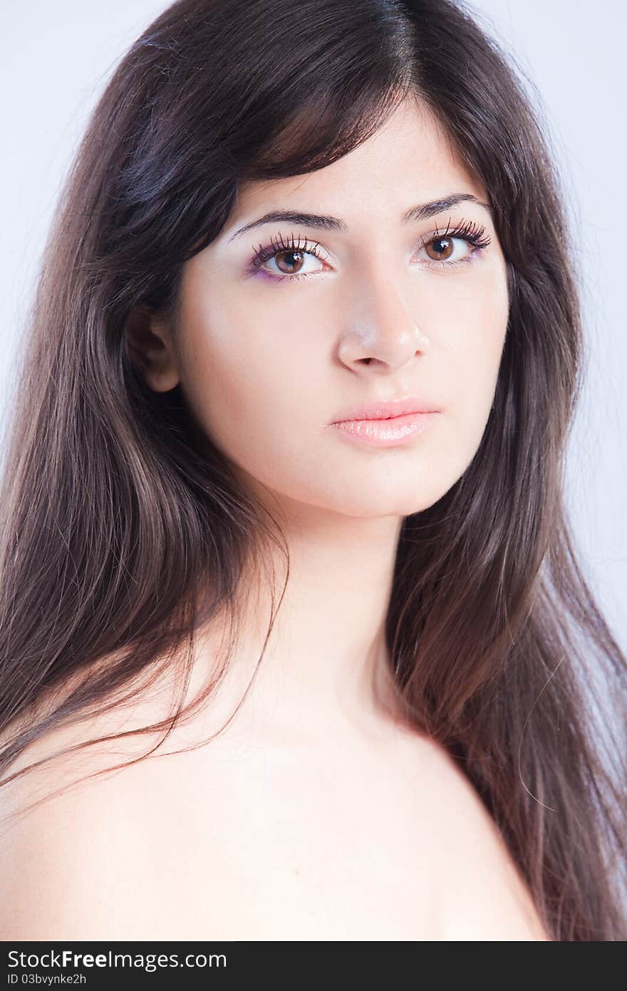 Pretty woman with long brown hair looking at camera, isolated on white background. Pretty woman with long brown hair looking at camera, isolated on white background