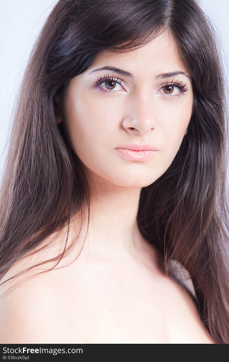 Pretty woman with long brown hair looking at camera, isolated on white background. Pretty woman with long brown hair looking at camera, isolated on white background