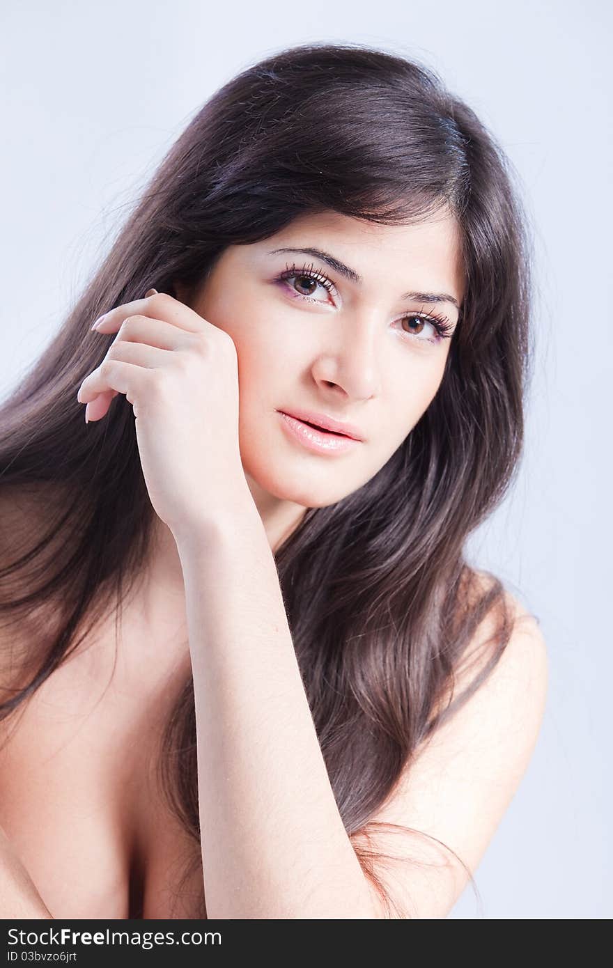 Pretty woman with long brown hair looking at camera, isolated on white background. Pretty woman with long brown hair looking at camera, isolated on white background