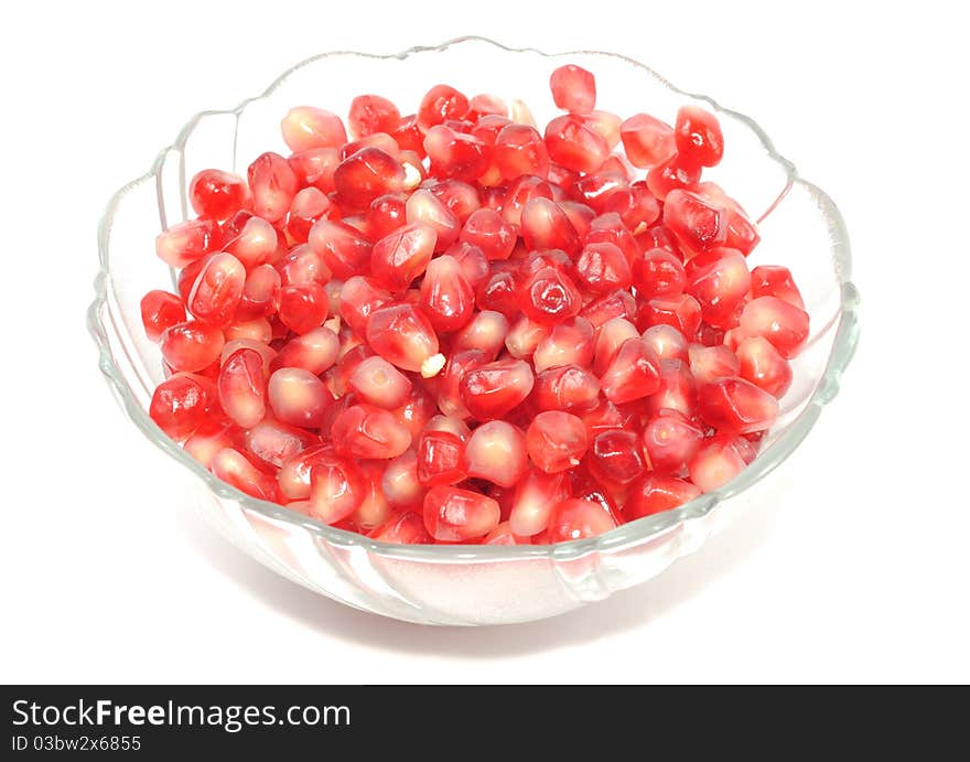 Pomegranate seets inside a glass plate isolated on a white background