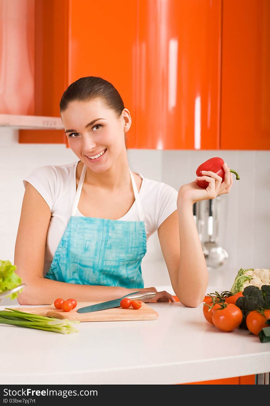 Woman In Her Kitchen Cutting Ingredients