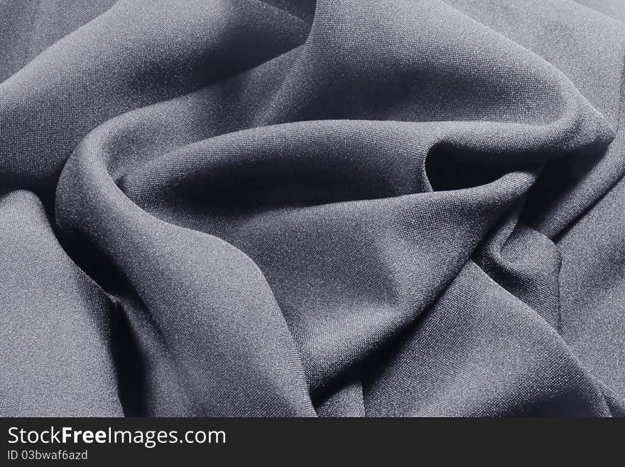 A close up of dark gray crumpled fabric. A close up of dark gray crumpled fabric