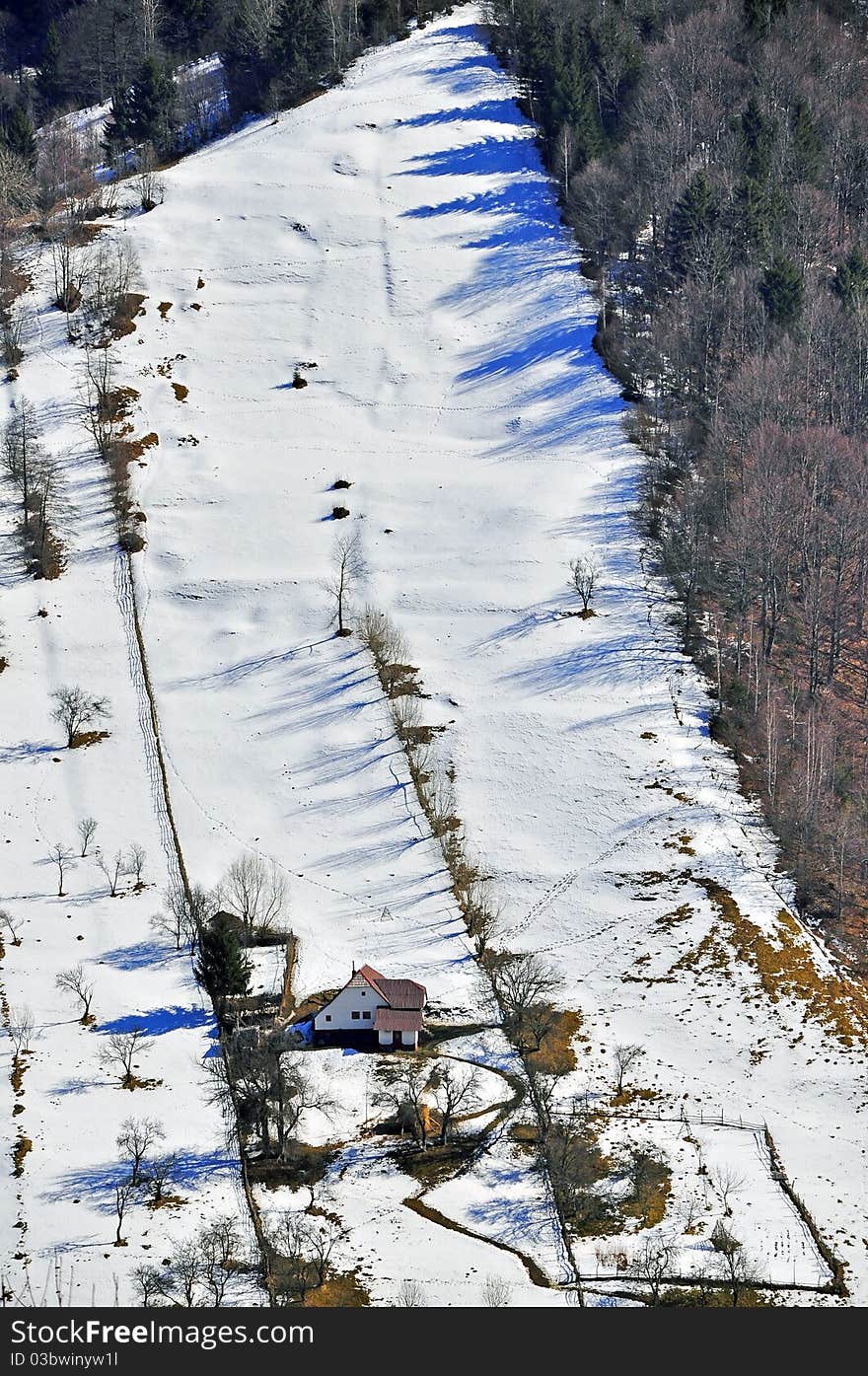 Isolated chalet in high winter mountains