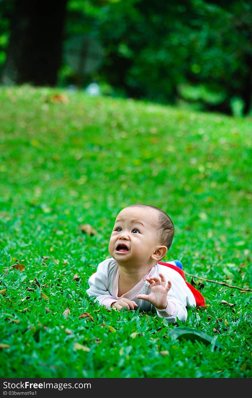 Baby boy is playing in a park after feeding time. Baby boy is playing in a park after feeding time