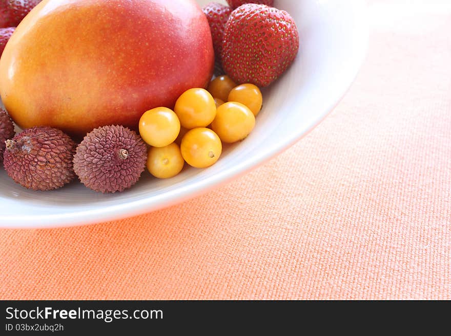 Variety of fresh fruits in a white bowl