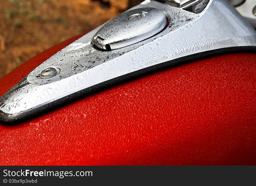 Red petrol tank morning dew