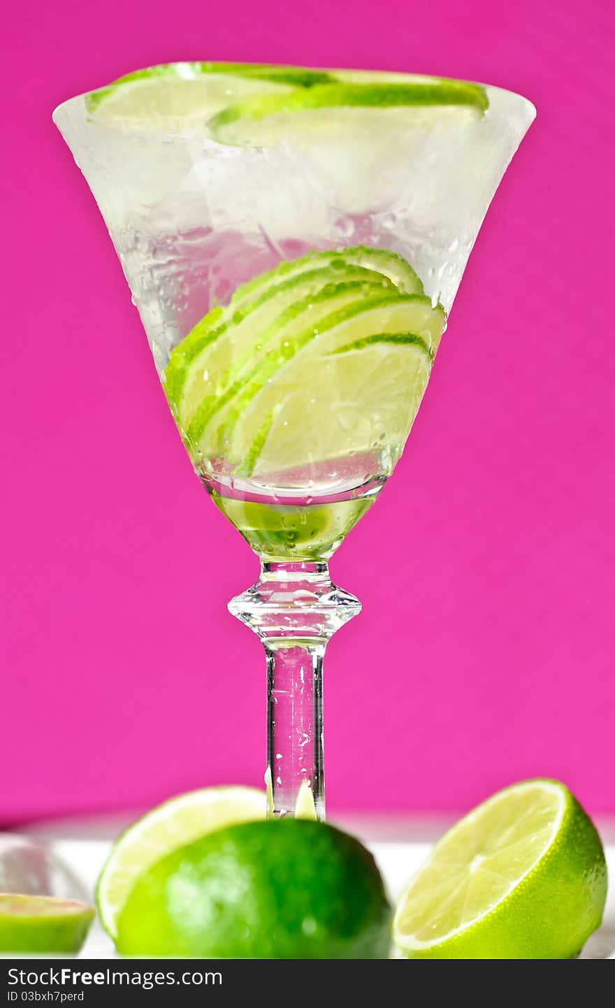 Cold summer drink with lime and ice