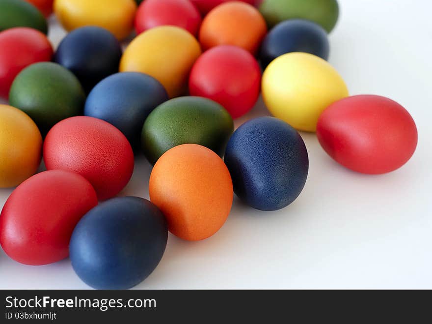 Painted Easter eggs scattered on the white background