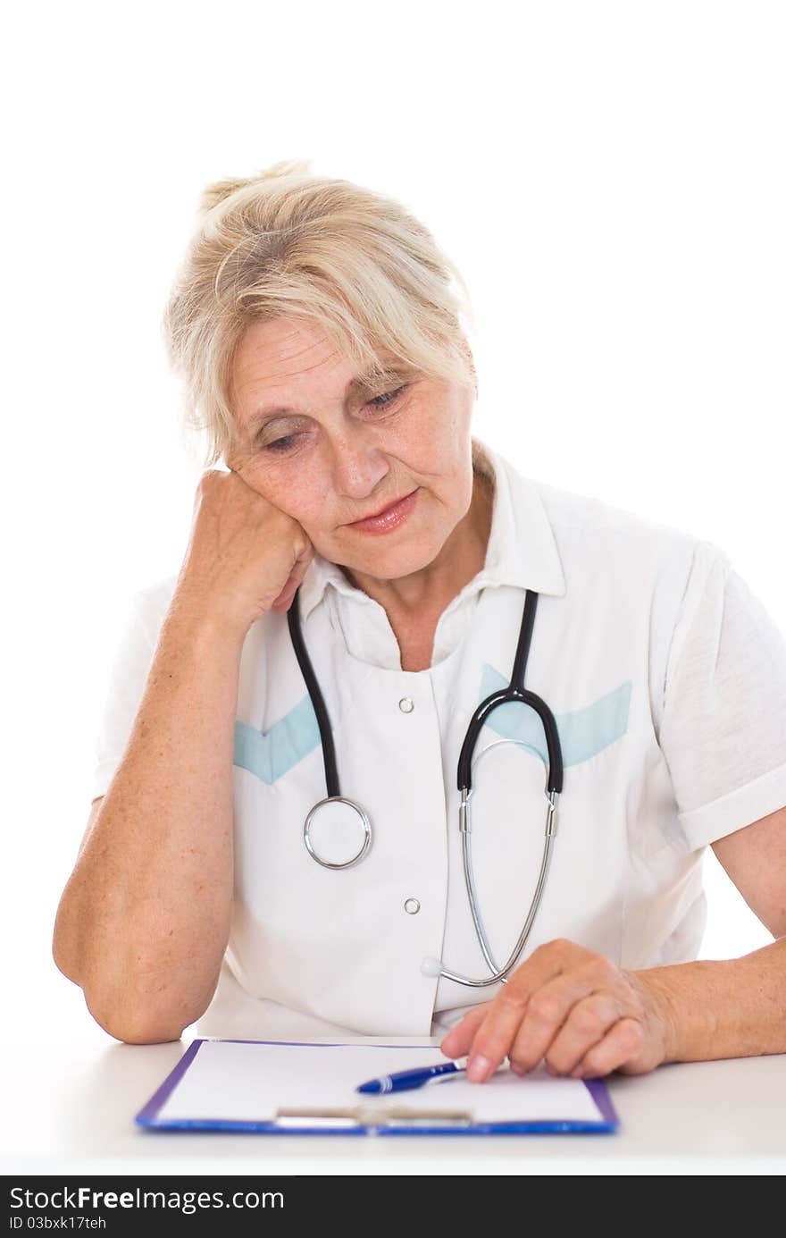 Elderly doctor sitting at the desk