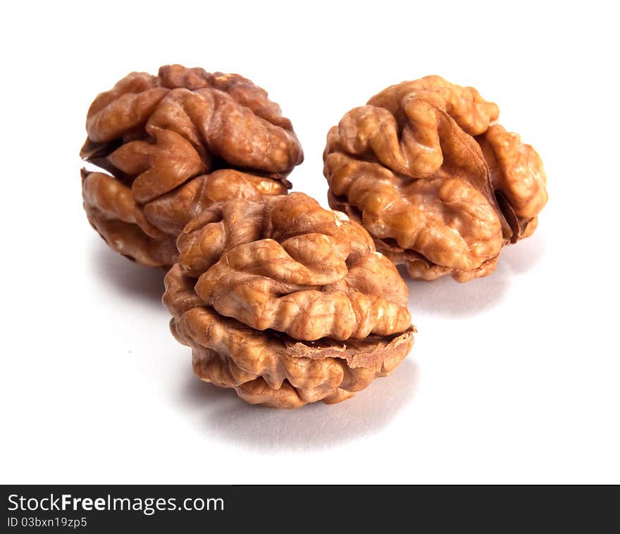 Three walnuts isolated on white background.