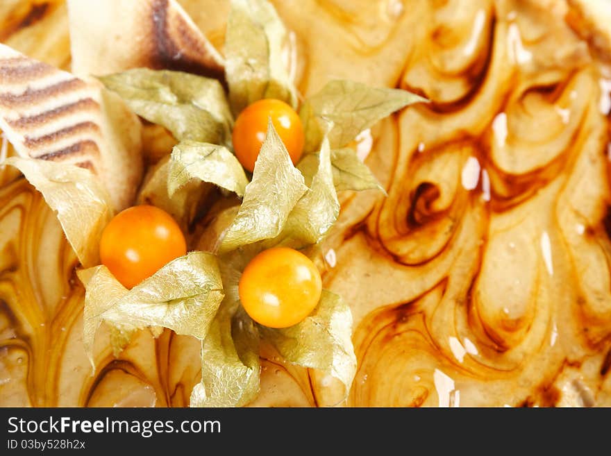 Closeup of caramel pie with decorative berries