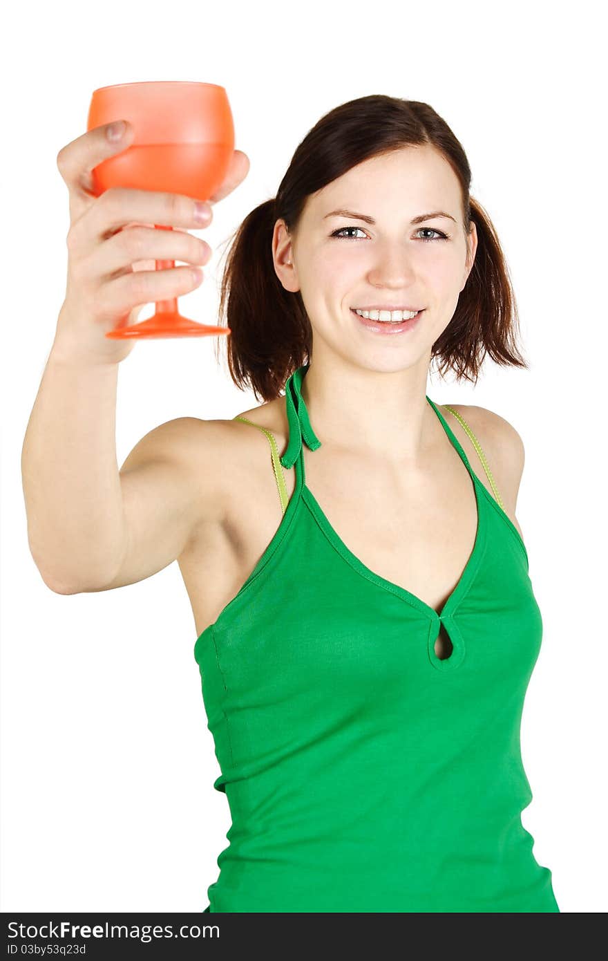 Young girl in green shirt holding orange glass and smiling, isolated. Young girl in green shirt holding orange glass and smiling, isolated