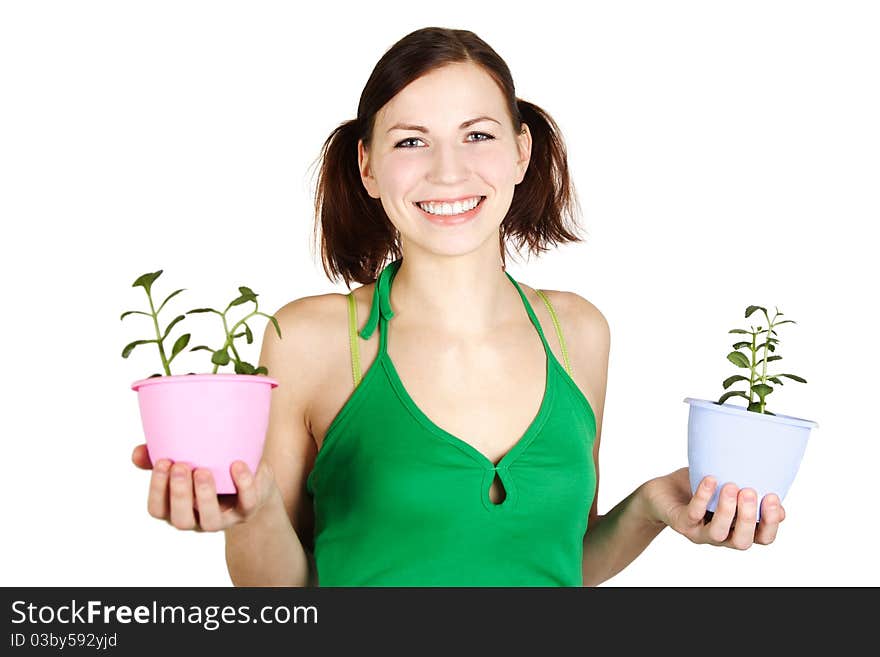 Young girl in green shirt holding potted plants and smiling, isolated. Young girl in green shirt holding potted plants and smiling, isolated