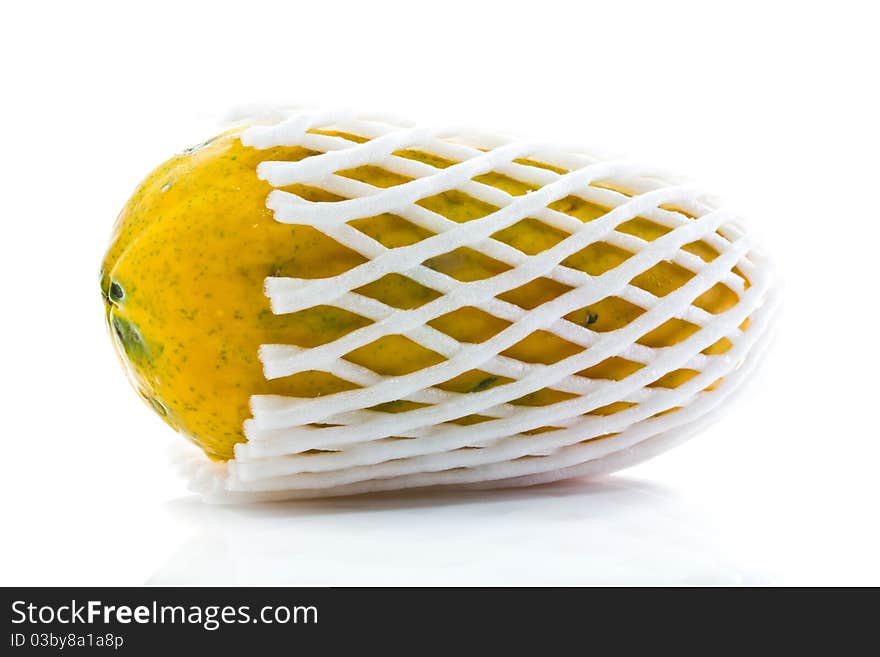 Yellow papaya in foam net isolated on white background