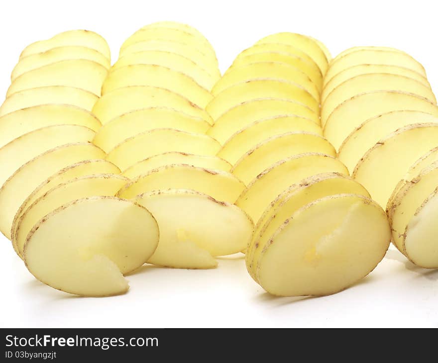 Raw potatoes cut in a spiral shot on a white background