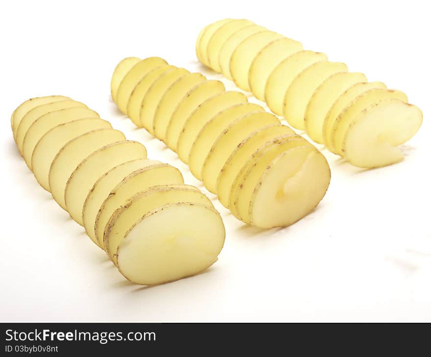 Raw potatoes cut in a spiral shot on a white background