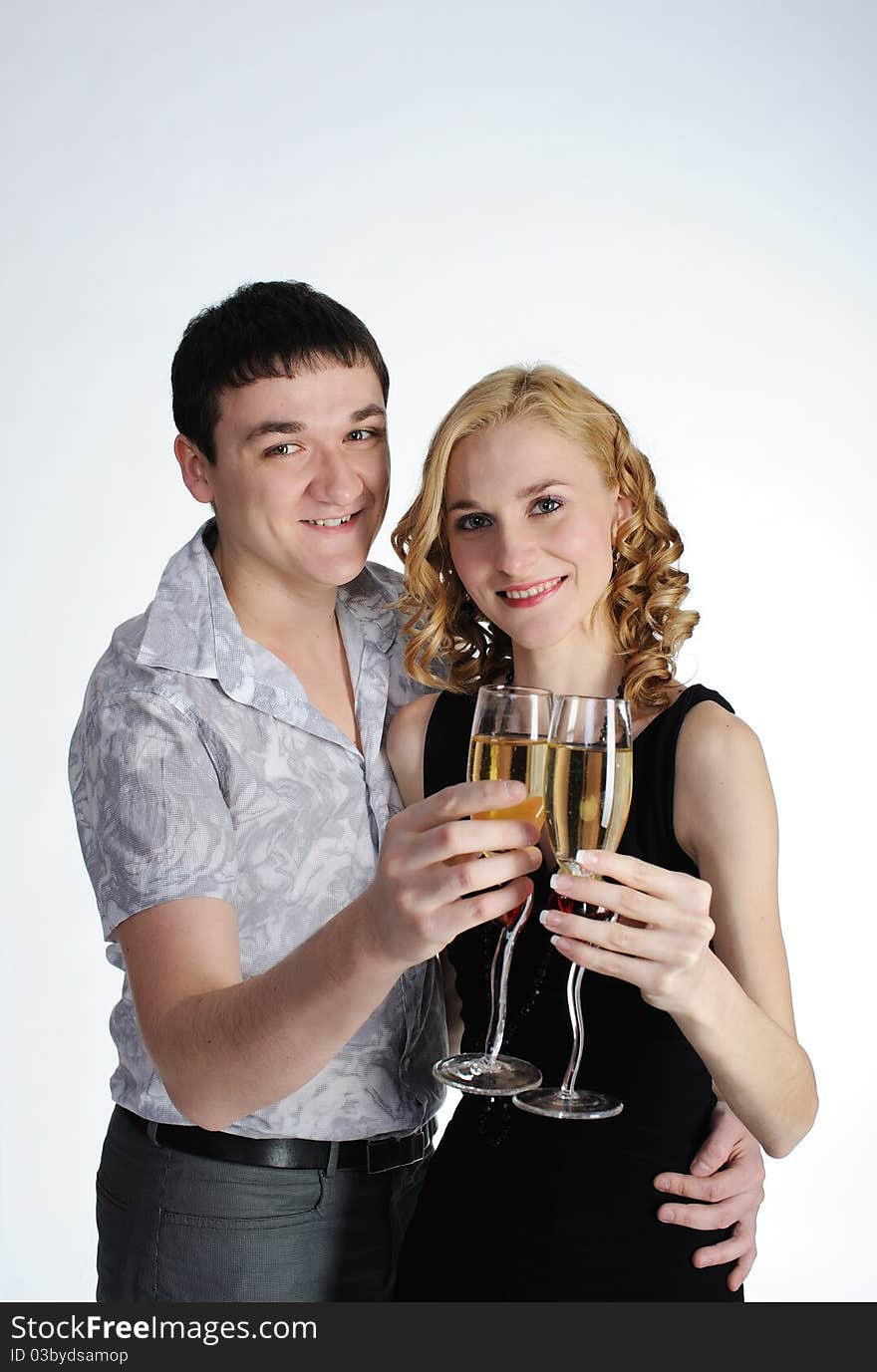 Happy couple of young girl and man drink champagne