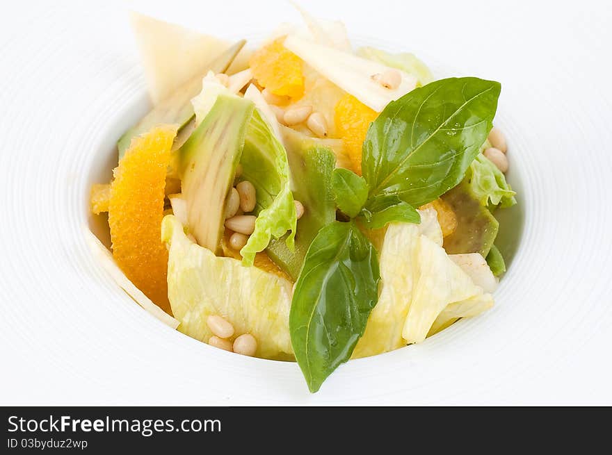 Salad from fresh vegetables close up on a white background