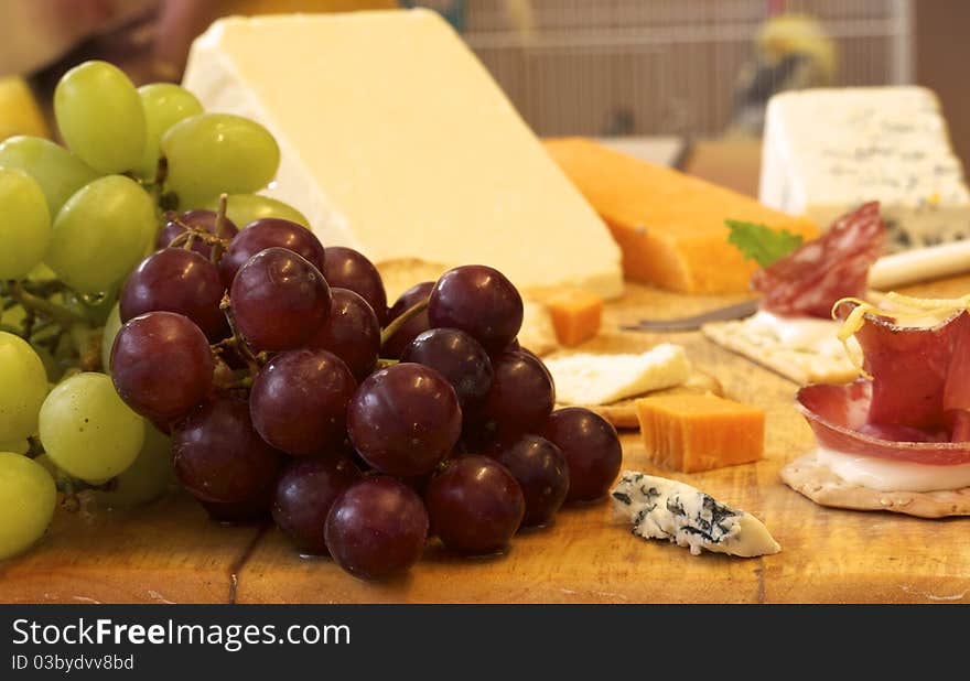 Selection of cheese and crackers with grapes