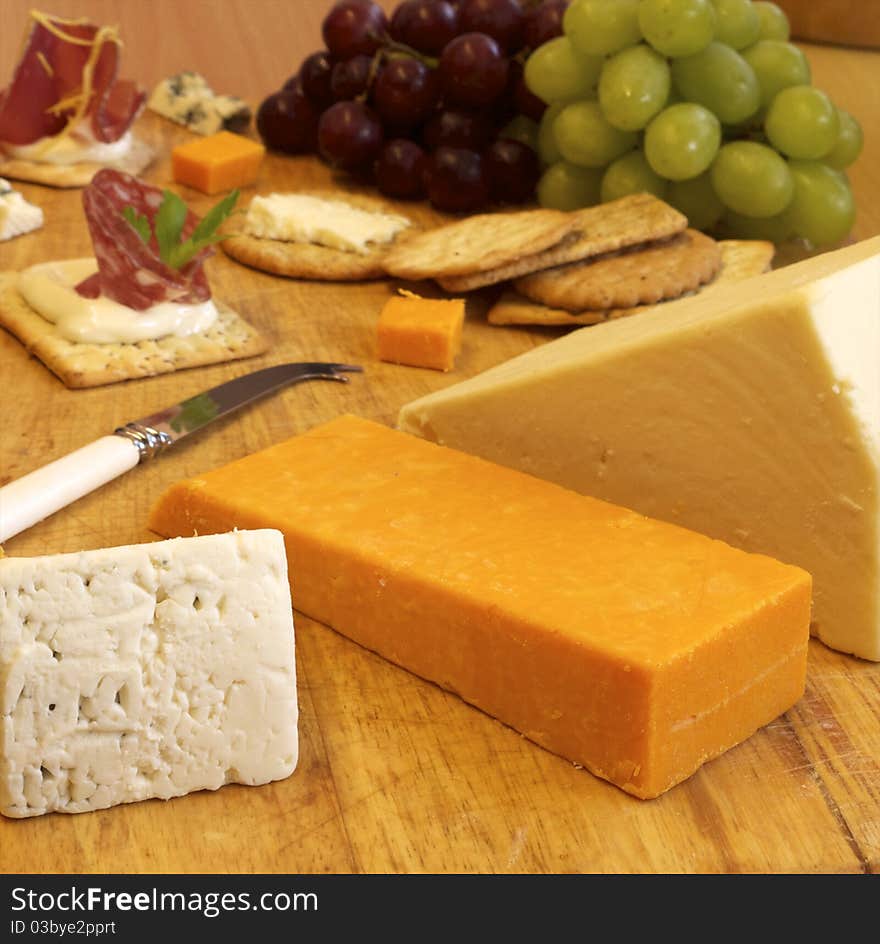 Selection of cheese and crackers shot on a wooden background