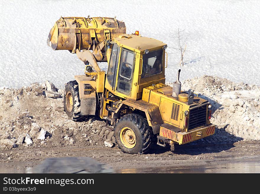 Process of cleaning of road from snow a heavy loader. Process of cleaning of road from snow a heavy loader