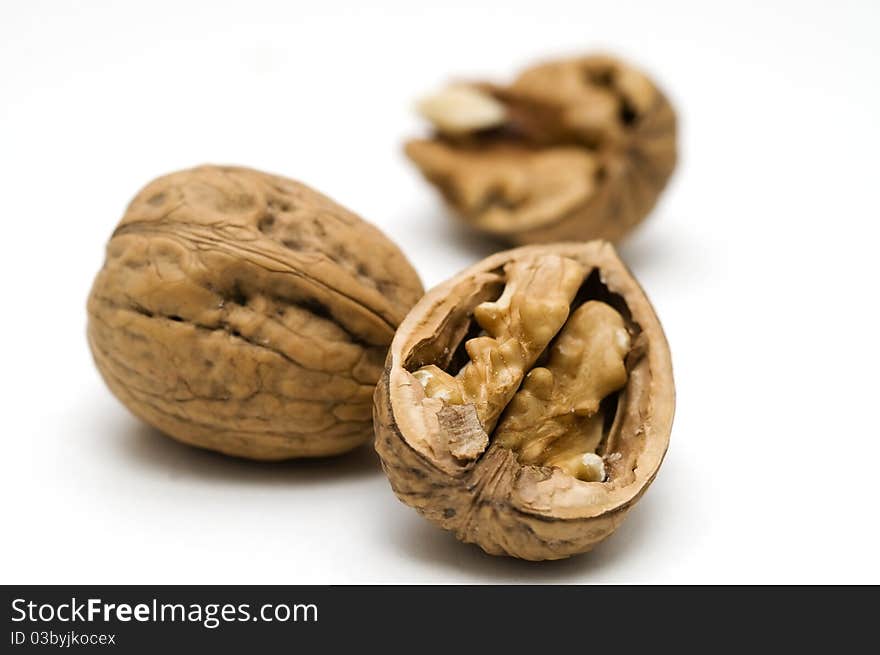 Walnut shell cracked on white background