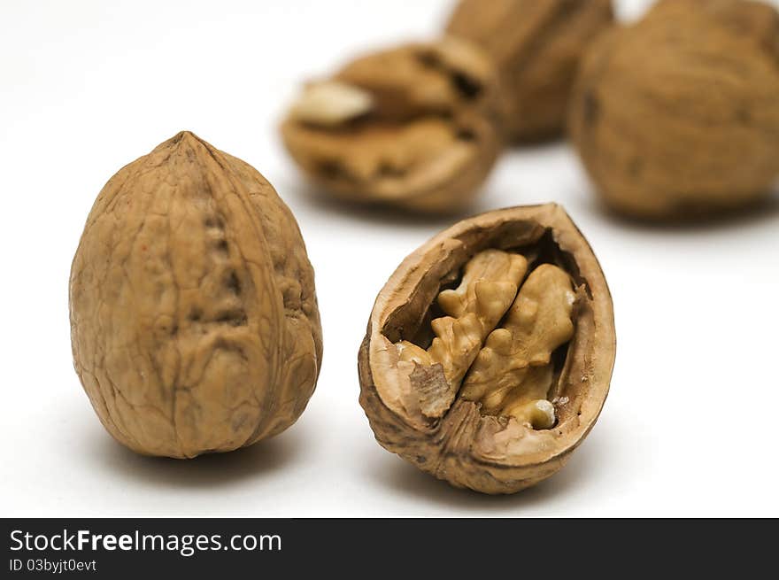 Walnut shell cracked on white background