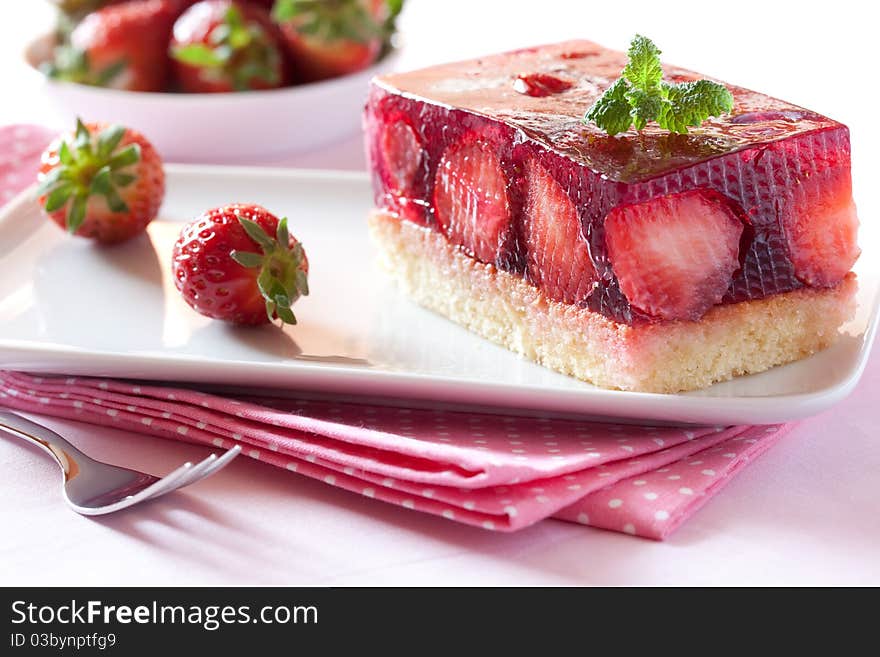 Fresh strawberry cake with mint leaf on plate