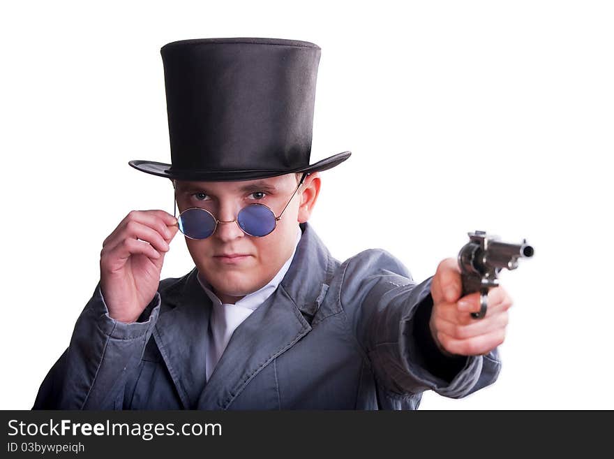 Portrait of the handsome man in a top-hat with a pistol in hand