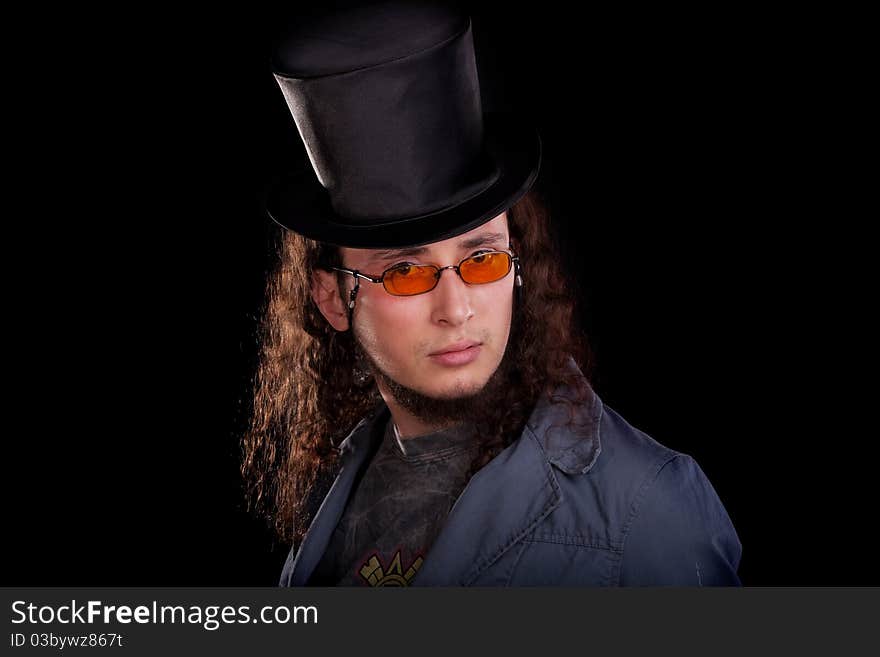 Portrait of the young serious man in a black top-hat