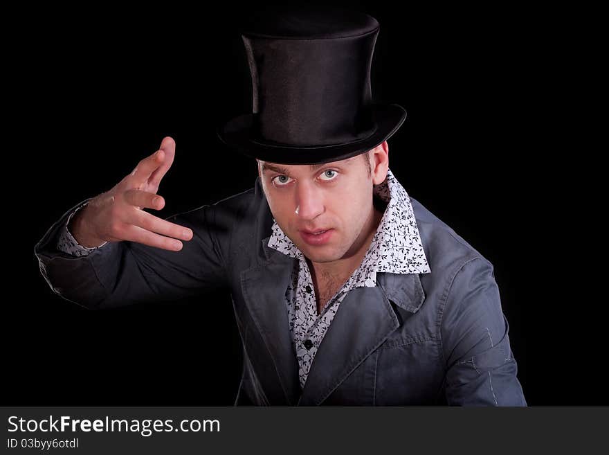 Emotional portrait of the young man in a black top-hat. Emotional portrait of the young man in a black top-hat