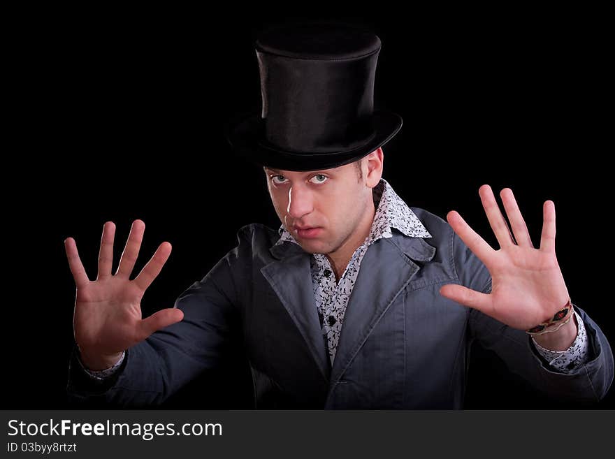 Emotional portrait of the young man in a black top-hat. Emotional portrait of the young man in a black top-hat