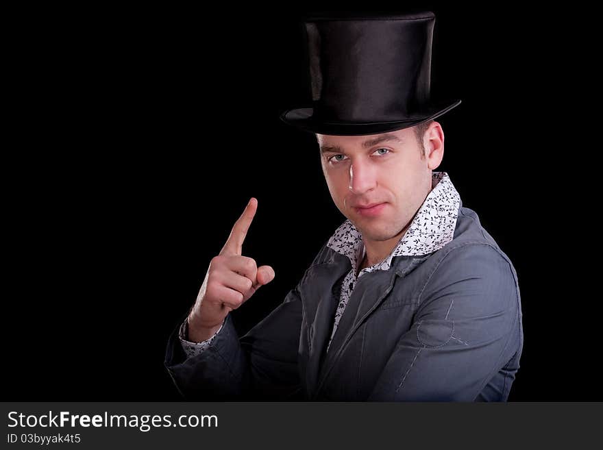 Emotional portrait of the young man in a black top-hat. Emotional portrait of the young man in a black top-hat