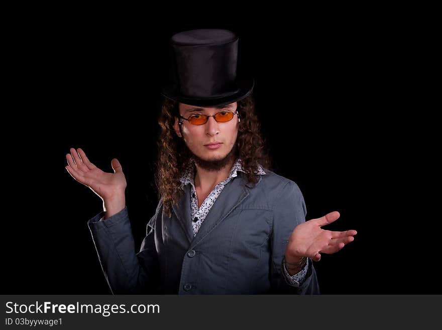 Portrait of the young serious man in a black top-hat