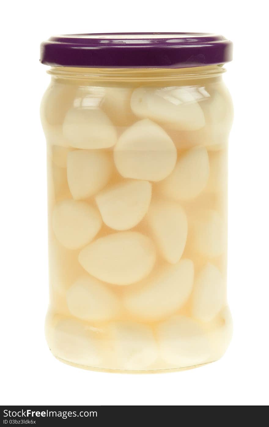 A jar of garlic pieces isolated on a white background