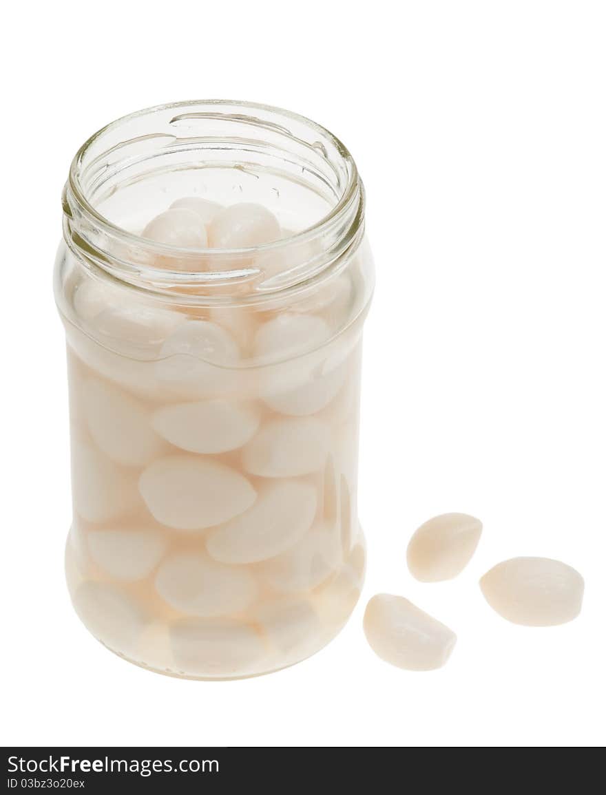 A jar of garlic pieces isolated on a white background