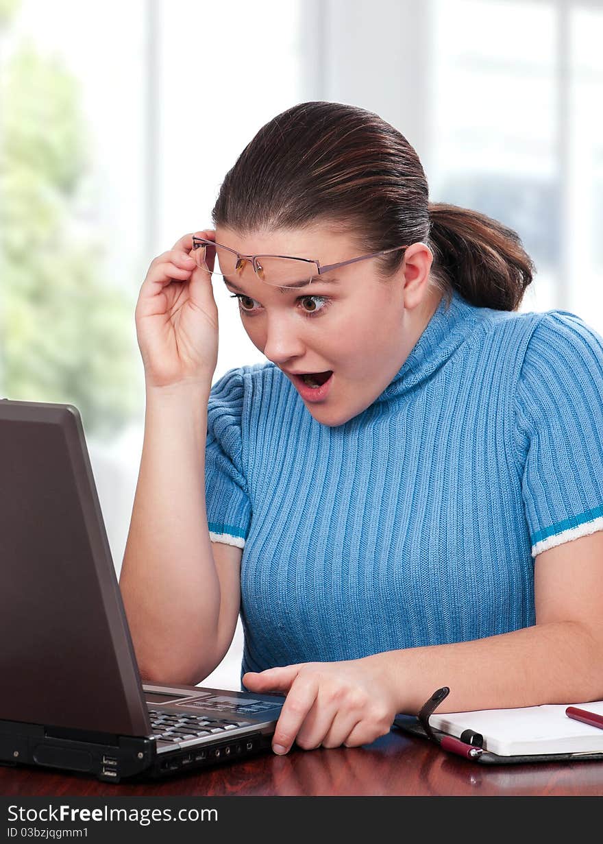 Beautiful businesswoman working with laptop at her office