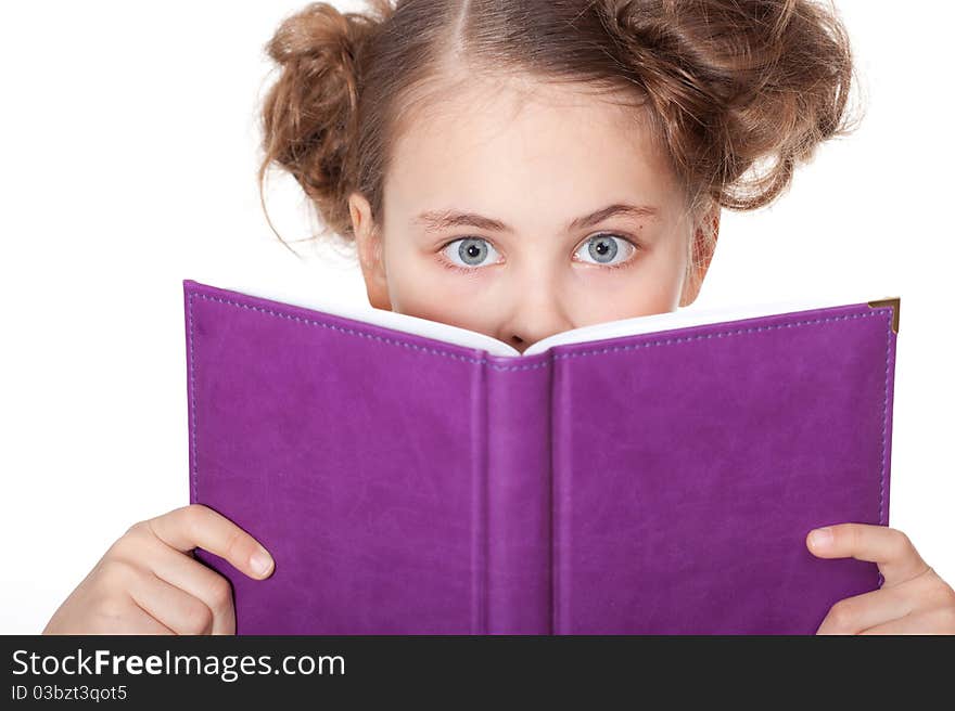 Cute little girl with beautiful eyes peeping behind the book. Cute little girl with beautiful eyes peeping behind the book