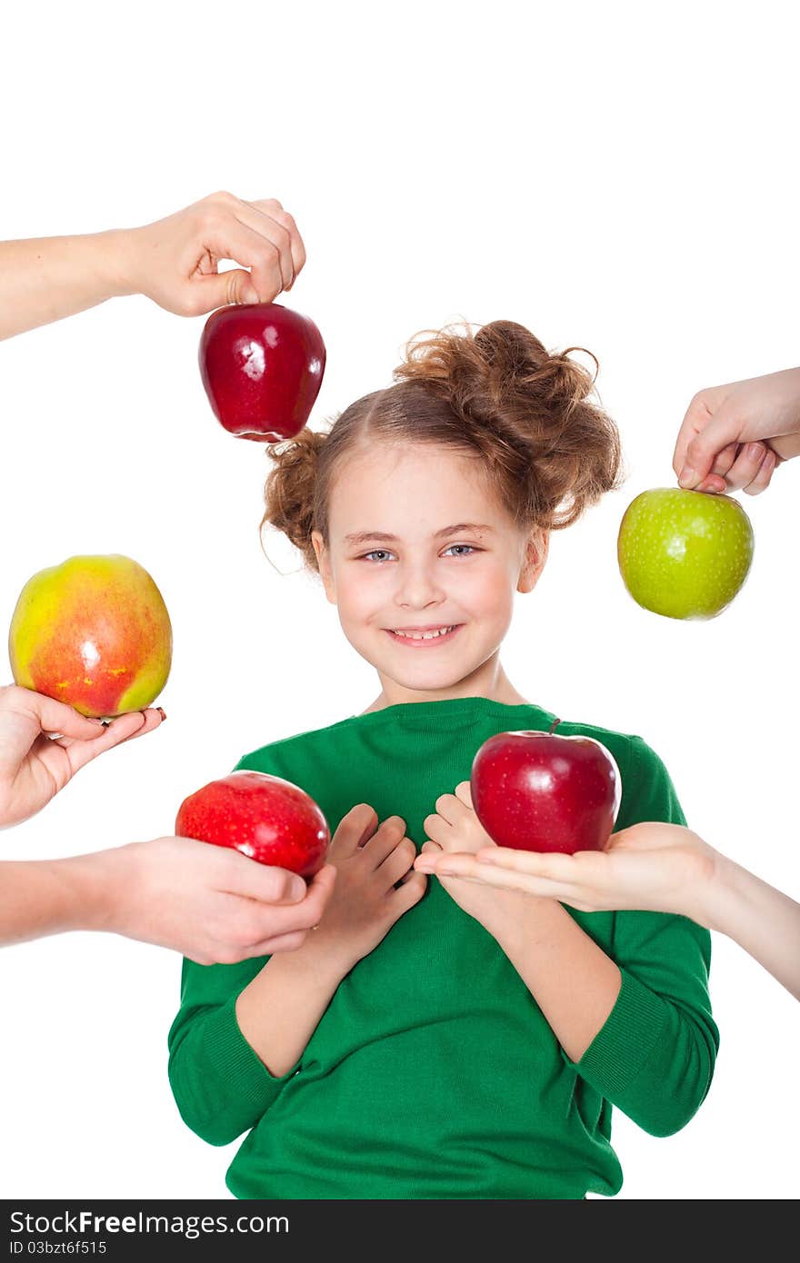 Closeup portrait of beautiful smiling girl choosing among proposed apples in people's hands. Closeup portrait of beautiful smiling girl choosing among proposed apples in people's hands