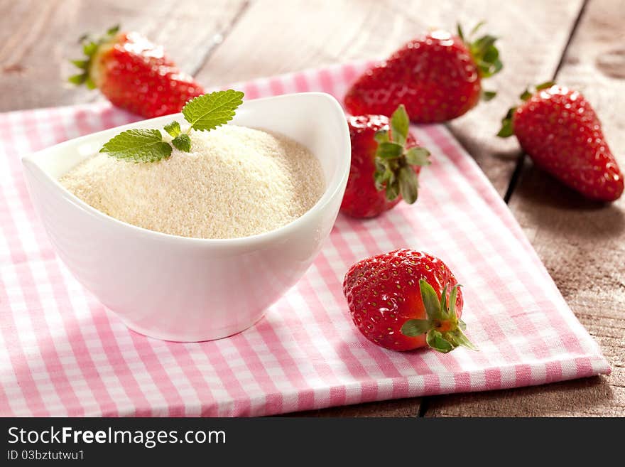 Semolina in bowl and strawberries. Semolina in bowl and strawberries