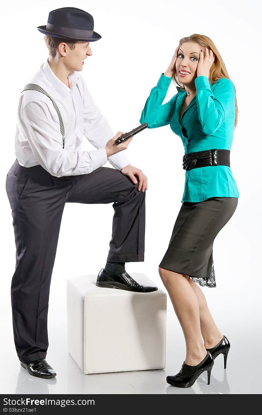 A Young Man In A Hat Threatens Gun Attractive Girl