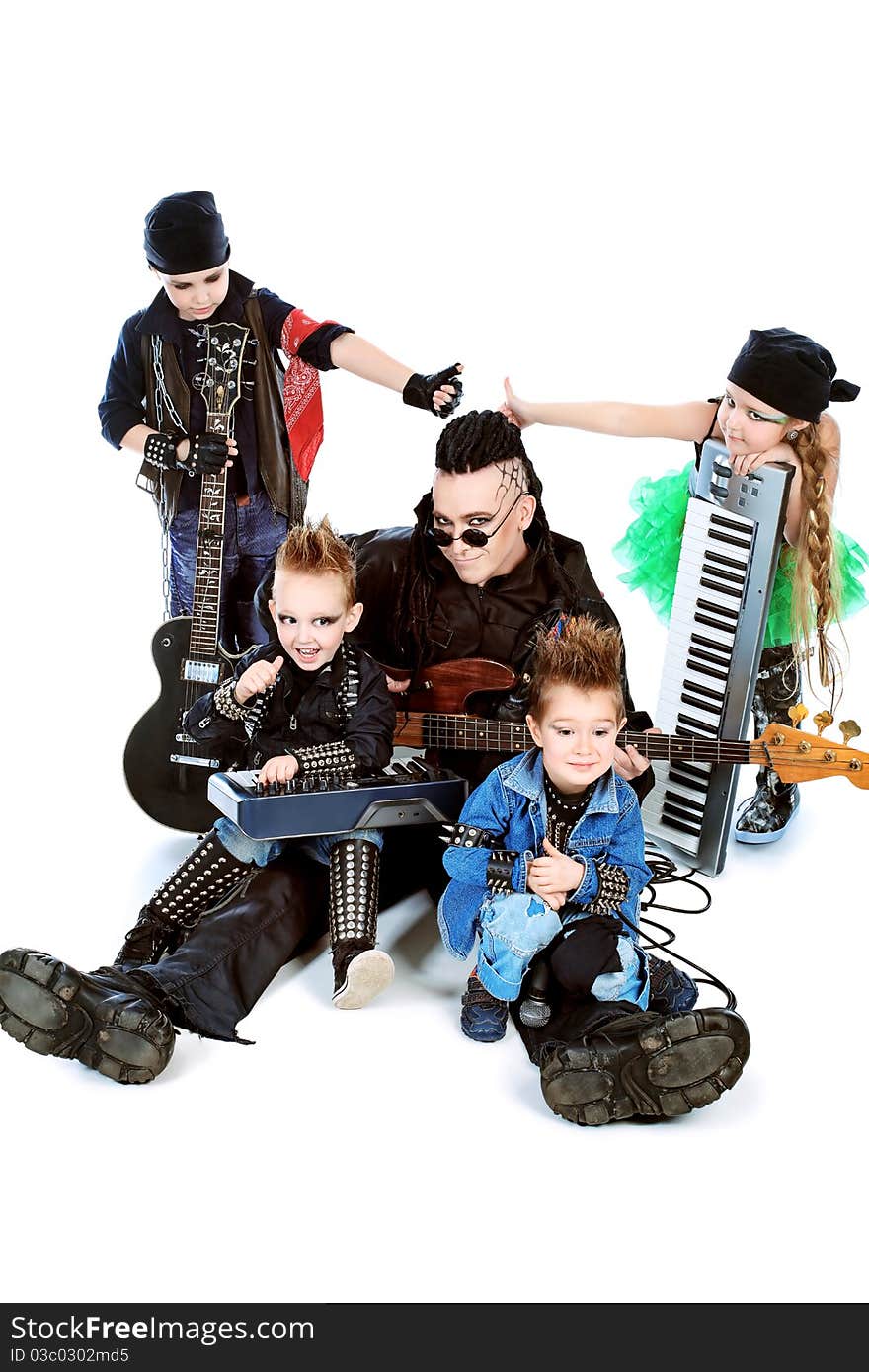 Heavy metal musician  with a group of stylish children. Shot in a studio. Isolated over white background. Heavy metal musician  with a group of stylish children. Shot in a studio. Isolated over white background.