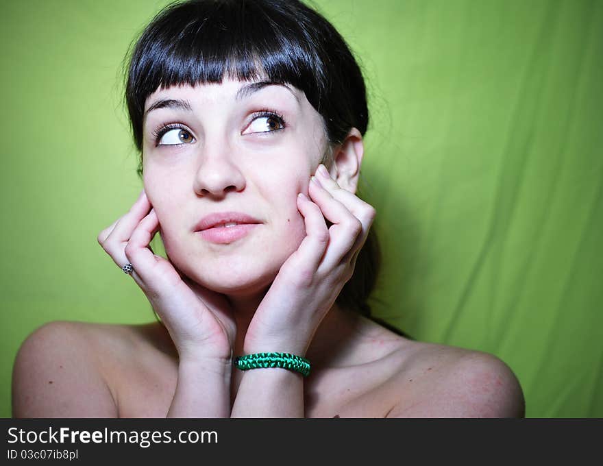 Close-up image of a beautiful girl posing, on a green background. Close-up image of a beautiful girl posing, on a green background