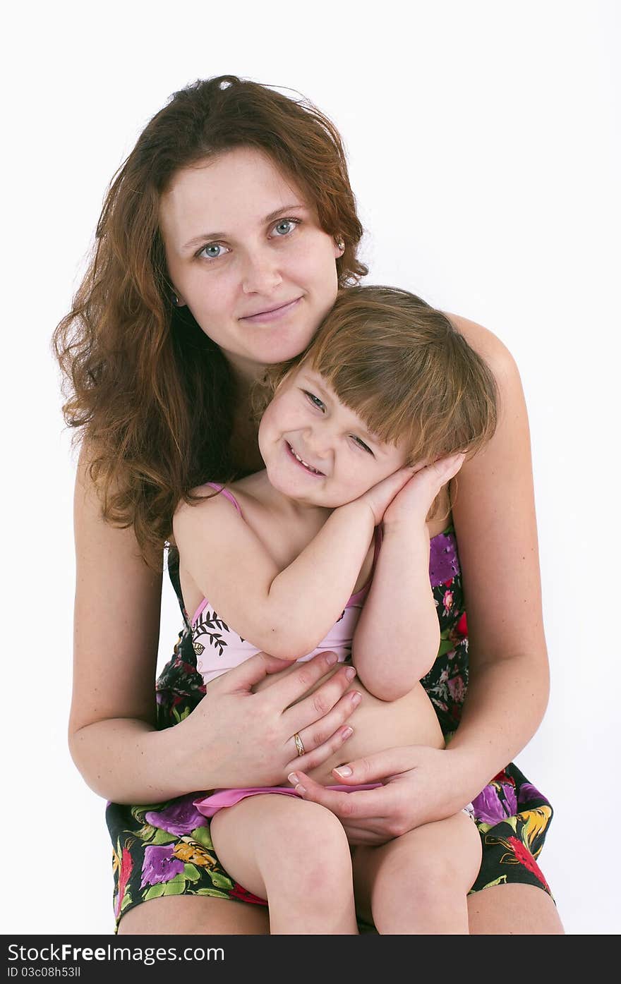 A Girl Sits On The Lap Of Her Mother.