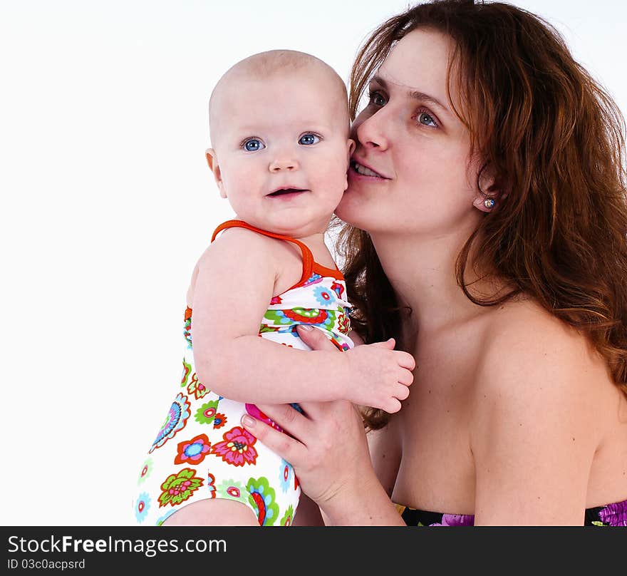 She smiles and wants to kiss the child .On a white background. .She smiles and wants to kiss the child .On a white background