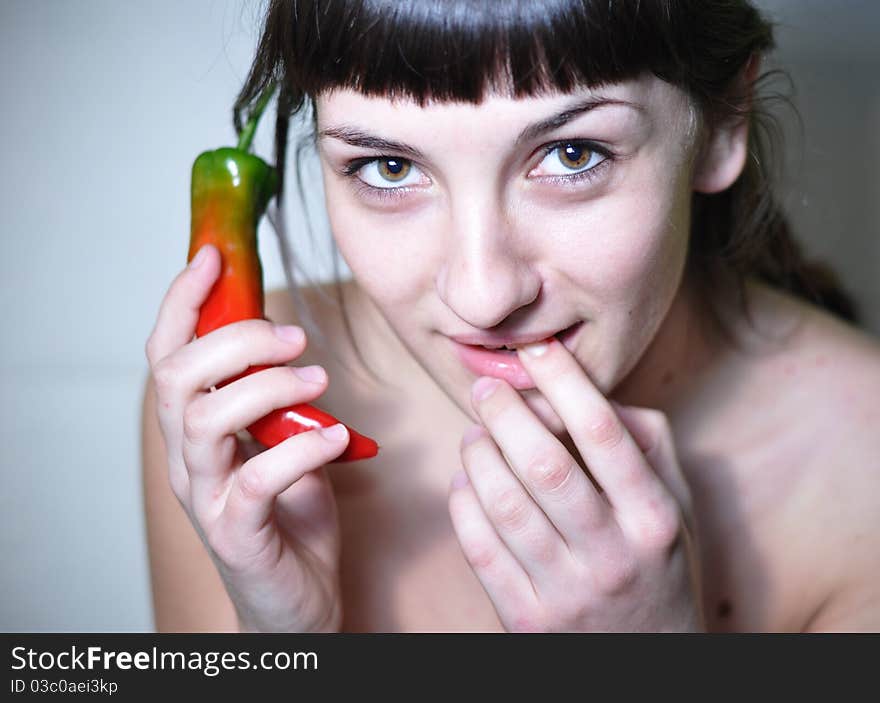 Woman holding hot peeper as a phone. Conceptual hot line. Woman holding hot peeper as a phone. Conceptual hot line