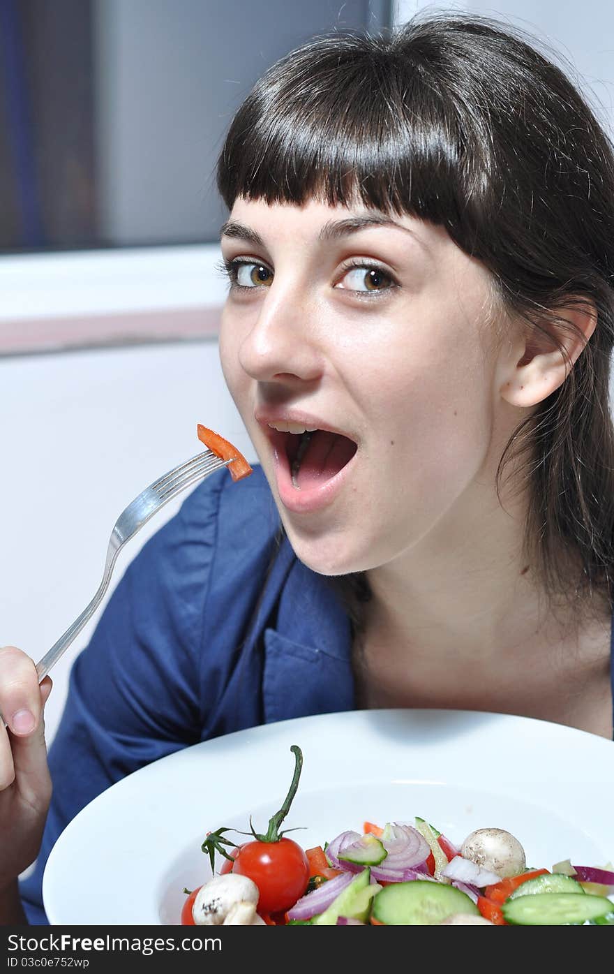 Woman eating salad