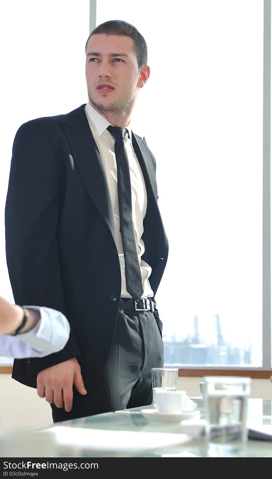 Young business man lawyer with laptop alone in big bright   conference room. Young business man lawyer with laptop alone in big bright   conference room