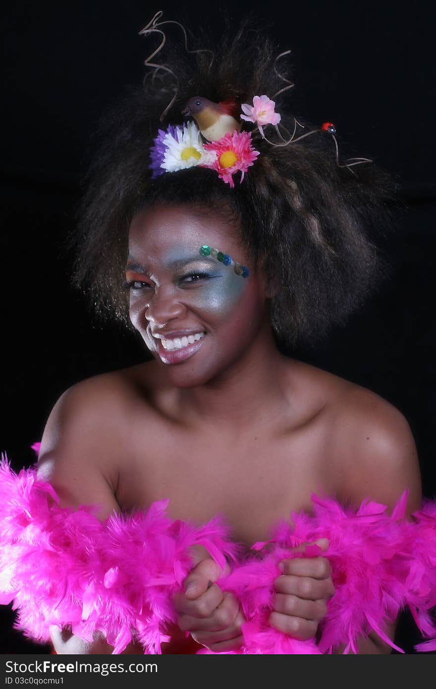 An African American woman wearing colorful makeup.