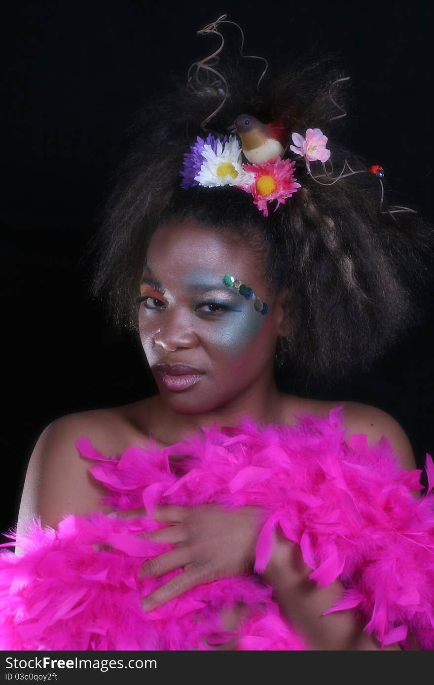 An African American woman wearing colorful makeup.